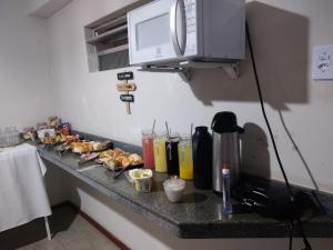 a counter with some food and drinks on it at Pousada Rose Alves in Cachoeiras de Macacu