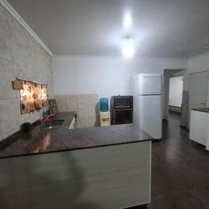 a kitchen with a counter top and a refrigerator at very spacious house equipped for 4 people in Resistencia