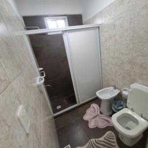 a bathroom with a shower and a toilet and a sink at very spacious house equipped for 4 people in Resistencia