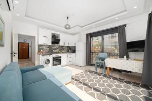 a living room with a blue couch and a kitchen at My house in Kaş in Kaş