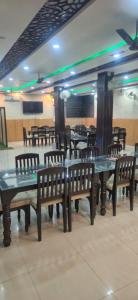 a dining room with tables and chairs and tables and benches at Hotel inn de dogras in Udhampur