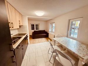 a kitchen with a table and chairs and a couch at Gemütliches Wohnung für Familien und Gruppen in Küblis