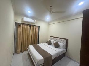 ein Schlafzimmer mit einem Bett und einem Fenster in der Unterkunft Rosebank service Apartment in Arpora + 17 Fotos