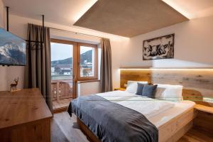 En eller flere senge i et værelse på Mannharthof Apartments