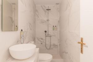 een witte badkamer met douche en toilet bij ILENA HOTEL in Acharavi