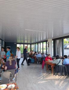 a group of people sitting at tables in a restaurant at Paradise House in Pamukkale +80 photos