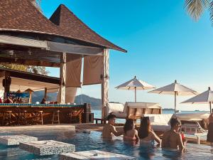 a group of people in the swimming pool at a resort at Koh Chang Resort in Ko Chang