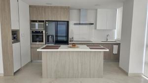 a kitchen with a island in the middle of it at Beautiful Ocean View Apt Salinas Malecon Pier in Salinas