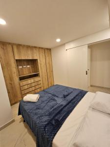 a bedroom with a bed with a blue blanket at Beautiful Ocean View Apt Salinas Malecon Pier in Salinas +34 photos
