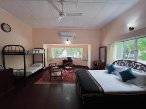 a bedroom with a bed and a table and chairs at The Deane Residence Family Room in Colombo