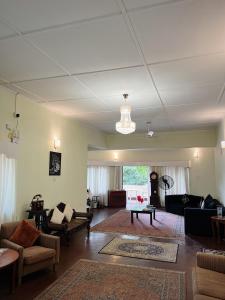 a living room with couches and a chandelier at The Deane Residence Family Room in Colombo