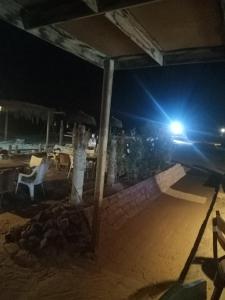 a table and chairs on a beach at night at Bella Sina Camp in Wāsiţ