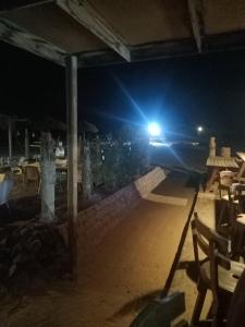 a patio at night with a table and chairs at Bella Sina Camp in Wāsiţ