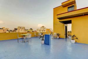 a balcony with tables and chairs on a building at Super Hotel O Royal Suites in Bengaluru