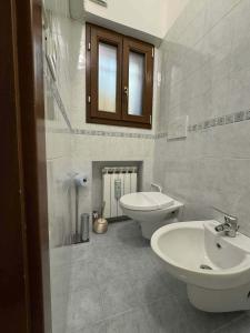 a white bathroom with a toilet and a sink at Ca' Malatin in Venice +30 photos