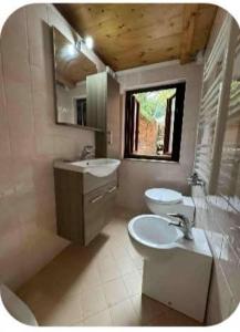 a bathroom with two sinks and a toilet and a mirror at Ca' Marcella in Venice +28 photos