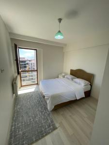 a bedroom with a white bed and a window at Flat in Samsun atakum in Atakum