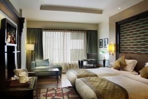 a large hotel room with two beds and a desk at The Fern, Jaipur in Jaipur