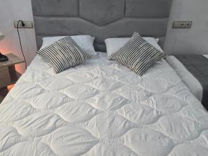 a white bed with two pillows on top of it at Hostel Dar Khelifa in Tétouan