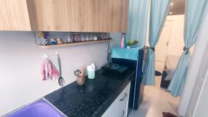 a kitchen with a black counter top in a room at NXone STUDIO APARTMENT in Noida