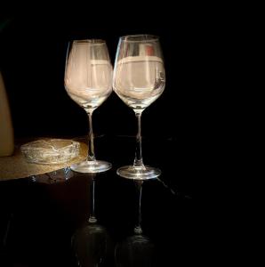 two wine glasses sitting on top of a table at NXone STUDIO APARTMENT in Noida