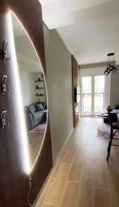 a living room with a circular mirror on the wall at Jahorina Lux in Jahorina