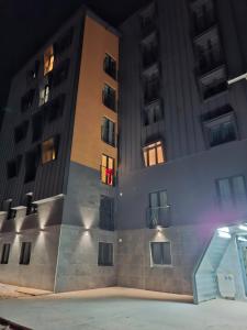 an apartment building at night with a ramp in front at Jahorina Lux in Jahorina