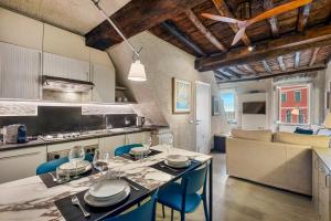 a kitchen and living room with a table and chairs at Marina Vista Apartment in Riomaggiore