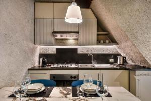 a kitchen with a table with wine glasses on it at Marina Vista Apartment in Riomaggiore