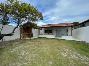 a house with a yard in front of a building at Brisa Mar in Canavieiras