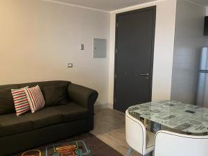 a living room with a couch and a table at Concón Apartment in Concón +3 photos