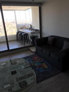 a living room with a couch and a table at Concón Apartment in Concón