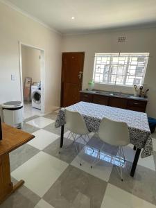 a kitchen with a table and chairs in a room at Williston Bly of Gly in Williston