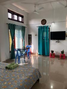 a bedroom with a bed and a table and chairs at Green Stay , AC room in Sibsāgar