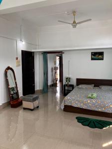 a bedroom with a bed and a ceiling at Green Stay , AC room in Sibsāgar