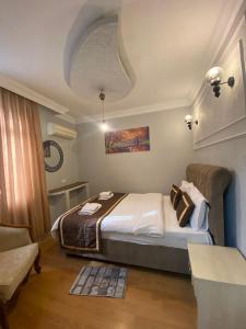 a bedroom with a bed and a couch at Divan Wooden Guesthouse in Istanbul