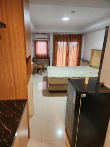 a room with a bedroom with a bed and a desk at Khodijah Homestay in Medan