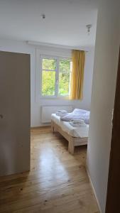 a bedroom with a bed and a window at Sunset View Apartment Bregenz Bodensee in Bregenz
