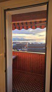 a window in a room with a view of a city at Sunset View Apartment Bregenz Bodensee in Tannenbach