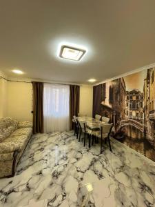 a living room with a table and a couch at Дома в Дилижане in Dilijan