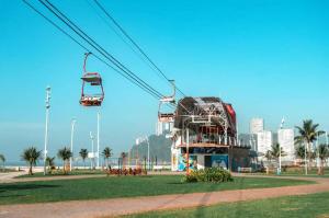 a gondola ride in a park next to the beach at Brisa do mar Kitinete in São Vicente