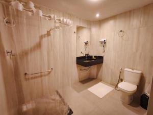 a bathroom with a toilet and a shower and a sink at Amazon Seasons hotel in Belém +23 photos
