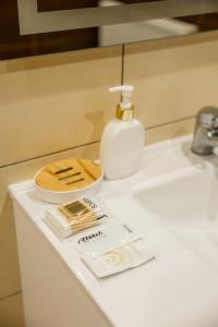a bathroom sink with a bottle of soap and a soap dispenser at Тіна in Slavske +68 photos