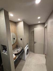 a bathroom with a washing machine and a sink at The Cozy Residence in Veria +17 photos