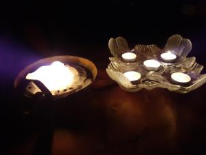 two lights with white candles in them in the dark at Inari lake modest cabin in Inari +38 photos