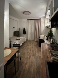 a room with a bed and a living room with a table at Cozy and Tiny Nest in Gudauri in Gudauri