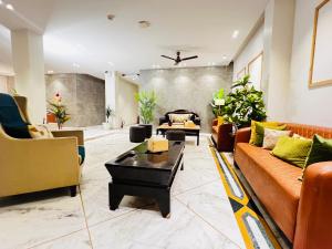a living room with couches and a coffee table at Divine Inn Hotel Near Rajouri Garden Main Market in New Delhi
