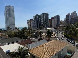 a city with tall buildings and a street with cars at Aconchego no Canto do Forte - Ar Condicionados - Tvs Grandes - Wi-fi e Estacionamento Incluso! in Praia Grande