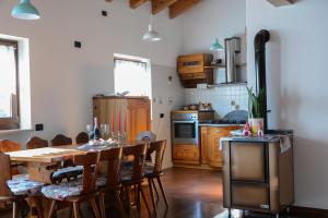 a kitchen with a table and chairs and a kitchen with a stove at Villa Nataly in Crosano