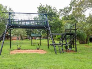 une balançoire dans un parc avec une aire de jeux dans l'établissement 26 on Greenway, à White River